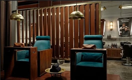 Velvet barber chairs and walnut screen